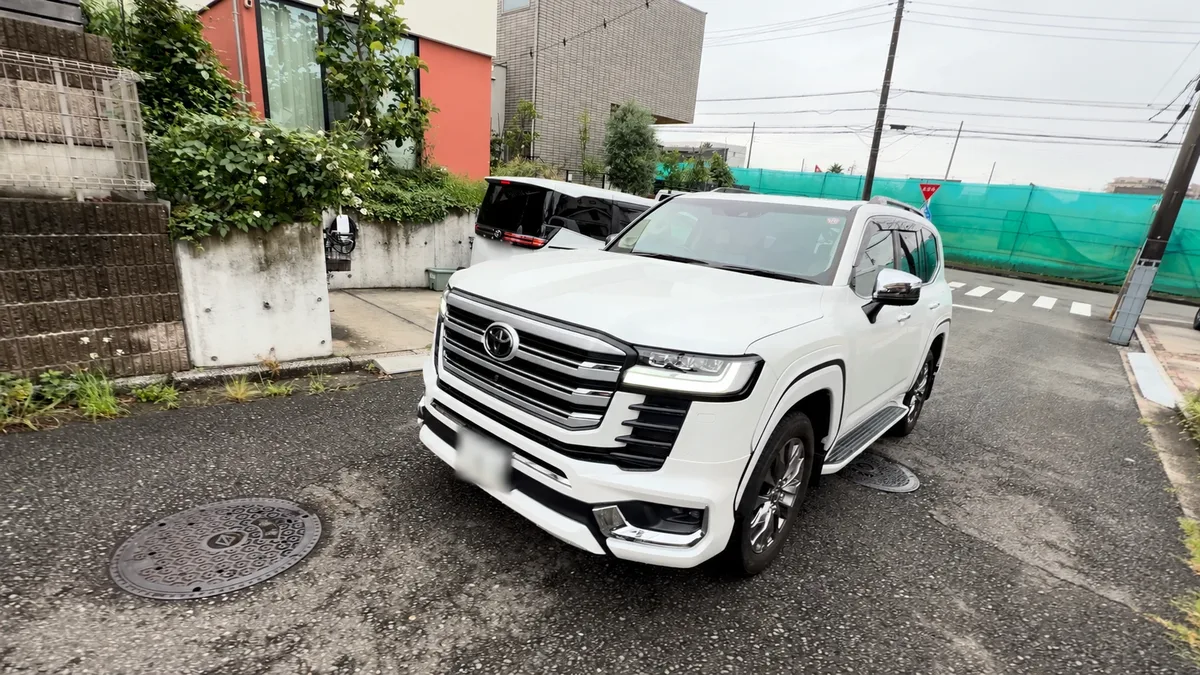 A white Toyota Land Cruiser parked on a street in Japan